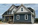 The home features gray siding, white trim, white windows, black roof, and a welcoming front porch at 70 Prency Ln, Middlesex, NC 27557