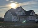 A partially finished home boasts a classic design with multiple windows under a sunny sky at 70 Prency Ln, Middlesex, NC 27557