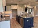 Open kitchen featuring a large island with granite countertops, stainless appliances, and ample storage at 70 Prency Ln, Middlesex, NC 27557