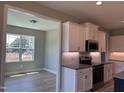 Kitchen featuring white cabinets, stainless appliances, and a view into the adjacent dining area at 70 Prency Ln, Middlesex, NC 27557