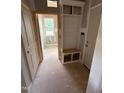 Well-organized mudroom with built-in storage bench, cubbies, and access to multiple rooms and exterior at 70 Prency Ln, Middlesex, NC 27557