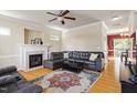 Spacious living room with a leather sectional sofa, fireplace, and large decorative rug at 801 Myrtle Grove Ln, Apex, NC 27502