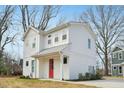 Angle view of the house that shows the white siding and bright red front door at 802 Pleasant Dr, Durham, NC 27703