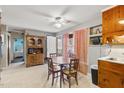 Bright dining area with tile flooring, wooden table and chairs, built in cabinets, and door to the exterior at 902 Bragg St, Sanford, NC 27330