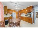 Charming kitchen with wooden cabinets, white countertops, stainless steel appliances, and a cozy dining area at 902 Bragg St, Sanford, NC 27330