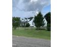 Beautiful two-story home with lush landscaping, a chimney, and a large front yard at 100 Blackberry Creek Dr, Willow Springs, NC 27592