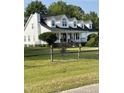 Classic two-story home with black shutters, a chimney, white trim, and large front yard at 100 Blackberry Creek Dr, Willow Springs, NC 27592