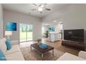 Bright open-concept living room featuring modern furniture, wood floors and sliding glass doors to the backyard at 101 Shelfit Trl, Oxford, NC 27565