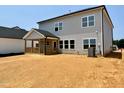 The backyard features a covered porch and fresh landscaping at 108 N Stonemill Trl # Homesite 254, Wilson's Mills, NC 27520