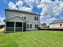 Expansive backyard with lush green grass, screened patio, and a well-maintained lawn at 108 N Stonemill Trl # Homesite 254, Wilson's Mills, NC 27520