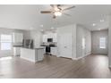 Open-concept kitchen featuring white cabinetry, granite countertops, stainless steel appliances and an island with breakfast bar seating at 110 Rhino Bnd, Oxford, NC 27565