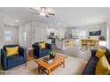 Inviting living room featuring modern furnishings, a ceiling fan, and seamless flow to the kitchen and dining area at 110 Rhino Bnd, Oxford, NC 27565