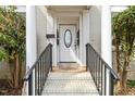 Close-up of the front door with decorative columns and a leaded glass window for added curb appeal at 1115 Wake Forest Rd # B, Raleigh, NC 27604