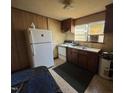 Compact kitchen with essential appliances, including a refrigerator, stove, and sink at 113 Smith St, Four Oaks, NC 27524