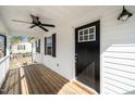 The front porch features a fan and black front door with glass windows at 120 W College St, Oxford, NC 27565