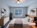 Staged primary bedroom with large window, closet and modern furnishings at 138 Parkdale Ln, Clayton, NC 27520