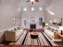 Bright living room with fireplace, ceiling fan, hardwood floors and modern decor at 138 Parkdale Ln, Clayton, NC 27520