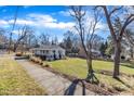 Expansive green lawn and trees surround this charming home with a covered front porch at 152 E Tryon St, Hillsborough, NC 27278