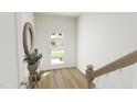 Bright entryway features wood flooring, a stylish door, and a decorative mirror at 173 Shakespeare Dr, Homesite 46, Durham, NC 27560