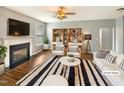 Bright living room featuring a fireplace, stylish furniture, and a zebra striped area rug at 1756 Main Divide Dr, Wake Forest, NC 27587