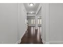 Bright hallway with hardwood floors leading into an open-concept living area at 1800 Bodwin Ln, Apex, NC 27502