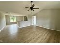 Bright living room featuring vaulted ceiling, ceiling fan, and beautiful wood-look flooring at 186 N Movado Trl, Kenly, NC 27542