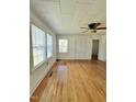 Bright room featuring hardwood floors, paneled ceilings, fan and bright natural light at 201 Colonial Ave, Goldston, NC 27252