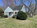 Quaint blue home with a well-kept lawn and mature trees at 214 Grace St, Oxford, NC 27565