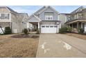 Charming two-story home with a covered front porch and a long driveway at 225 Ivy Arbor Way, Holly Springs, NC 27540