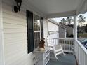 Cozy porch featuring a comfortable rocking chair, complemented by a charming side table and decorations at 254 Pedernales Dr, Smithfield, NC 27577