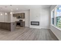 Open concept kitchen with island, stainless steel appliances, and modern lighting at 256 Chesapeake Commons St # 157, Garner, NC 27529
