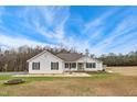 Traditional single-story home with a manicured lawn, landscaping, and inviting entrance at 2650 Spring Hill Rd, Spring Hope, NC 27882