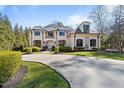 Beautiful white home showcasing elegant architecture and a lush, green lawn at 2710 Cambridge Rd, Raleigh, NC 27608