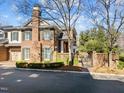 Beautiful brick house with manicured landscaping and an iron gate, perfect for outdoor entertaining at 2820 Glenwood Gardens Ln # 101, Raleigh, NC 27608