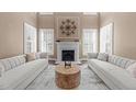 Elegant living room with fireplace, neutral tones, plantation shutters, and an eye-catching centerpiece at 2820 Glenwood Gardens Ln # 101, Raleigh, NC 27608