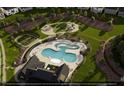 Community pool and playground, surrounded by manicured lawns and sidewalks at 3012 Dog Rose Dr # 305, Durham, NC 27703