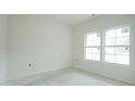 This bedroom features two large windows, flooding the room with natural light at 303 E C St, Butner, NC 27509