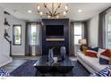 Inviting living room featuring a modern chandelier, dark accent wall, and plush seating at 33 White Azalea Way, Homesite 80, Benson, NC 27504