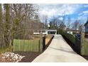 Gated home with a long driveway and exterior gate at 3650 Durwood Ln, Raleigh, NC 27604