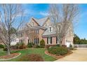 Beautiful two-story home with brick and siding, lush lawn, and mature trees at 3708 Wesley Ridge Dr, Apex, NC 27539