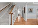 Welcoming foyer with hardwood floors, staircase, and views to other rooms at 3708 Wesley Ridge Dr, Apex, NC 27539