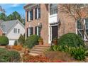 Lovely brick front porch with manicured shrubs and potted plants leading to the front door at 3708 Wesley Ridge Dr, Apex, NC 27539