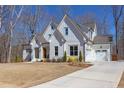 Charming white home with a concrete driveway and three-car garage, nestled on a lush, green lawn at 3901 Laurel Creek Ln, Wake Forest, NC 27587