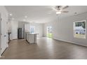 Open-concept living area featuring luxury vinyl flooring, an island kitchen, and lots of natural light at 507 Benton Dr, Oxford, NC 27565
