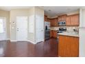 Modern kitchen featuring stainless steel appliances and a spacious open layout with dark wood floors at 5315 Glenmorgan Ln, Raleigh, NC 27616