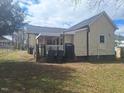 Backyard view of a charming home in a yard that needs landscaping attention at 614 Oak St, Burlington, NC 27215