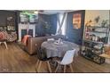 Cozy dining area featuring a table with four chairs and laminate flooring throughout the room at 614 Oak St, Burlington, NC 27215