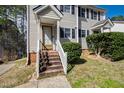 Close-up of the front door and entryway with brick steps and manicured bushes at 6221 Tributary Dr, Raleigh, NC 27609
