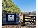 Stone entrance sign for Alder Creek community surrounded by lush trees at 69 White Azalea Way, Homesite 81, Benson, NC 27504