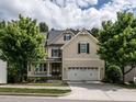 Beautiful two-story home with a welcoming front porch, two-car garage, and manicured lawn at 730 Toms Creek Rd, Cary, NC 27519